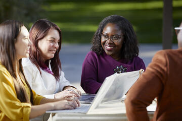 group studying at table outdoors